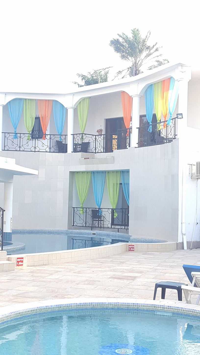 The swimming pool at Luigi's Complex surrounded by tropical gardens